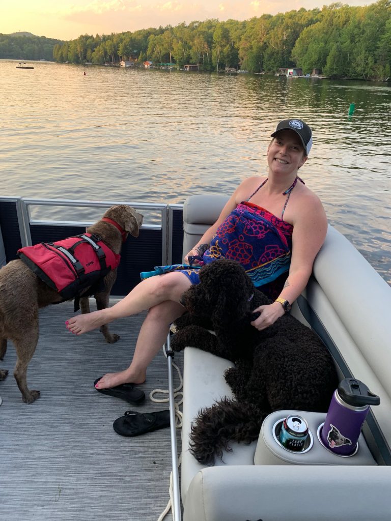 girl dogs lake boat summer